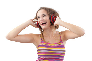 Portrait of young joyful woman who is listening to music through red headphones, looks to the side with her blue eyes, while being isolated on a white background