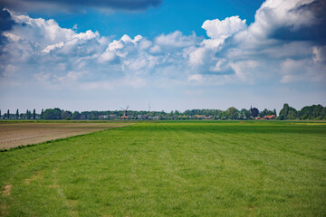 Quaint Dutch Village with Windmill and Dike Houses