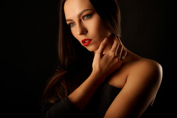 Portrait of a beautiful girl in the studio on a black background.