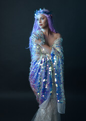 artistic portrait of beautiful female model with long purple hair wearing a fantasy fairy crown,...