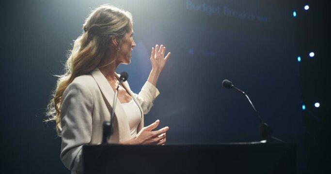 Tech Entrepreneur Talking Business Partnership and Venture Capital on Stage. Businesswoman Standing Behind a Podium Stand, Talking About Project Management and Finance at an International Event