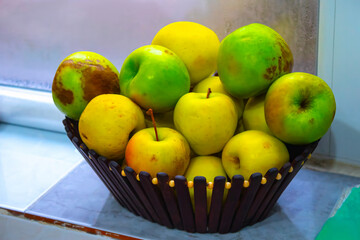 yellow apples in basket on the table