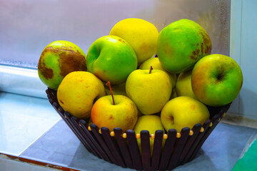 yellow apples in basket on the table