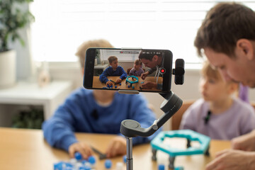 Kids play a new board game for their blog, recording a fun and interactive game session