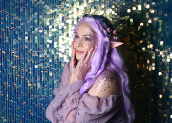 portrait of cute female model with long purple hair wearing a fantasy fairy flower crown with elf...