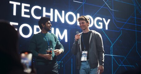 Two Young Technology Business Founders are Welcomed on Stage at a Global Tech and Innovation Conference. Charismatic Hosts are Opening the Event, Talking on Stage, Entertaining the Guests