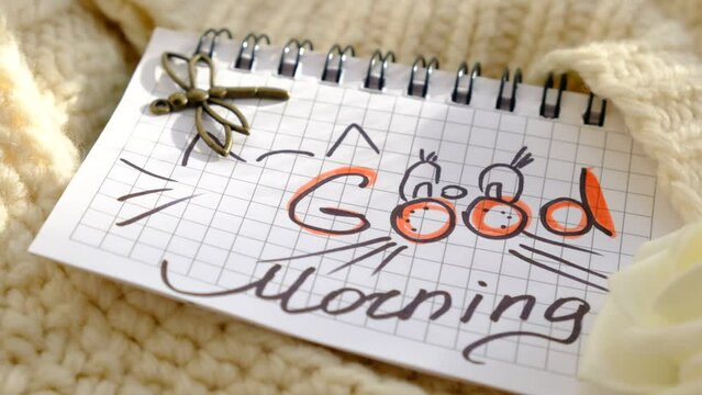 Text Good Morning on paper, notepad. Motivation. Love. Atmospheric mood. Cute kitten picture