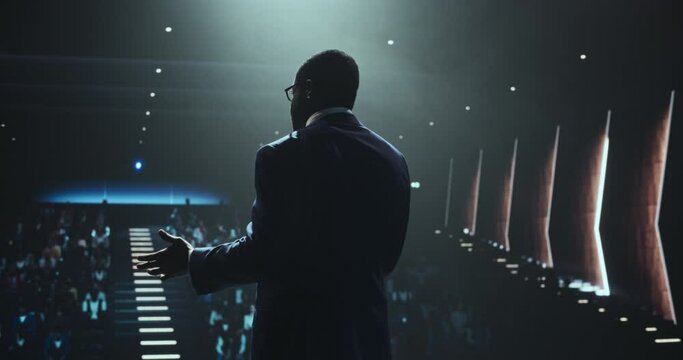 Black Man Making a Life Coaching Session for People Wishing to Have a Healthy and Successful Personal and Professional Life. African Lifestyle Specialist Making a Presentation to a Big Audience