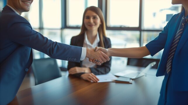 A businesswoman shaking hands with a human resources manager after a job interview, hiring concept.
