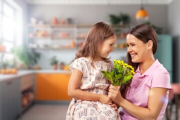 Mother's day concept. Child congratulating mother giving bouquet of flowers.