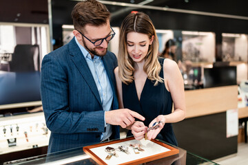 Beautiful couple enjoying in shopping at modern jewelry store. Men fashion and elegance  concept.