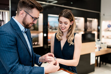 Beautiful couple enjoying in shopping at modern jewelry store. Men fashion and elegance  concept.