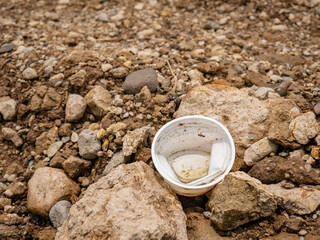 plastic waste in the form of glass on the rocks

