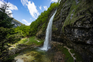 Fontanon of Goriuda, Udine. Wonderful waterfall that falls from a cliff. The force of the waterfall...