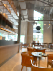 A blurred image of a modern coffee shop, elegantly decorated and warm, with customers happily working