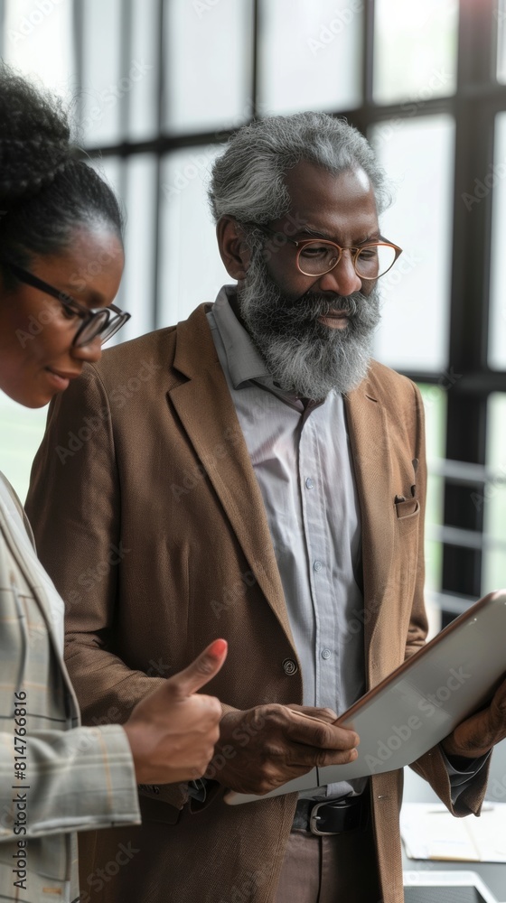 Poster a man and a woman looking at something on a tablet