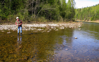 beautiful woman Tourist travels along the rocks of the Southern Urals on a spring day