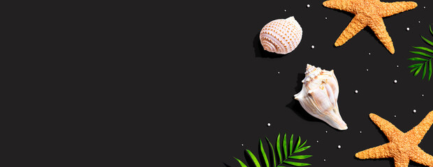 Summer concept with starfish and seashells overhead view - flat lay