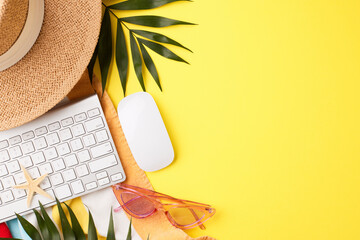 Top view of a remote work setup with a keyboard, sunglasses, and tropical elements on a yellow background, suitable for content on summer workspaces