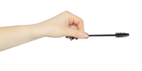 eyelash brush in hand, outstretched hand with eyelash brush isolated from background