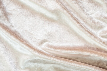 Beige gold velvet background or velour flannel texture made of cotton or wool with soft fluffy velvety satin fabric cloth metallic color material