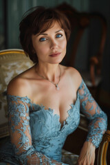 Naklejka premium The essence of natural beauty and confidence, a middle-aged woman with short dark hair, elegantly adorned in an azure lace dress, exudes grace and self-assurance as she gazes directly at the camera.