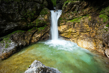 Naklejka premium Rio di Repepeit. Wonderful waterfall that falls from a cliff. The force of the waterfall is a sight to behold. Hiking, trekking in the open area surrounded by woods. Summer holidays, peace.