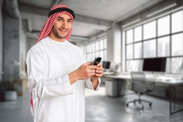 Handsome arab man with traditional clothing hold phone