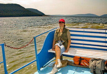 beautiful young woman on a pleasure boat on the Nugush reservoir in the Southern Urals on a summer sunny day