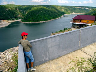 mature tourists in the southern Urals against the backdrop of the Yumaguzin dam on the white river