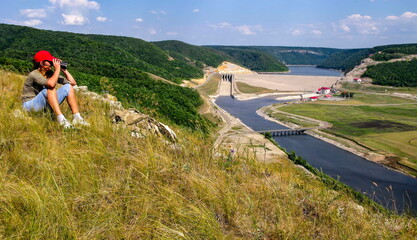 mature tourists in the southern Urals against the backdrop of the Yumaguzin dam on the white river