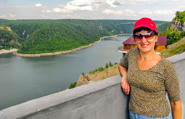 mature tourists in the southern Urals against the backdrop of the Yumaguzin dam on the white river
