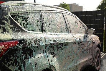 At the car wash, the car is completely covered with foam (part of the series 
