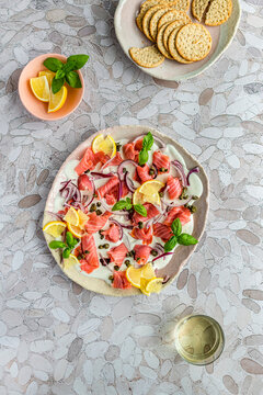 Beetroot Salmon Board with Lemon, Red Onion, Capers on a bed of labneh