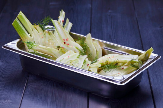 Fresh fennel pieces in metal bowl