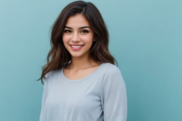 Fototapeta premium Beautiful young Hispanic woman smiling against the blue background with copy space.