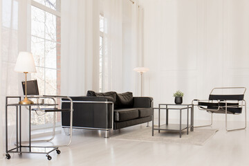 A bright room with large windows and modern furniture