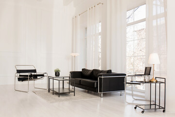 A bright room with large windows and modern furniture