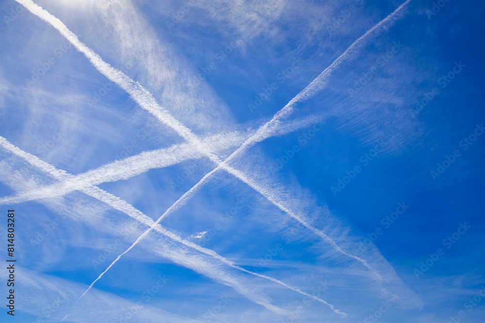 Wall mural aircraft contrails over blue sky.