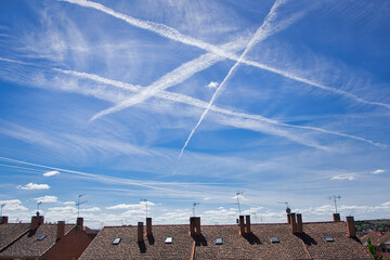 Aircraft contrails over blue sky.
