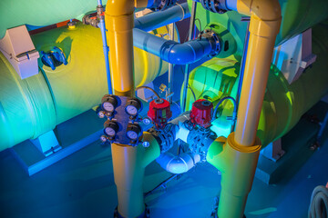 Colorful industrial tanks with control valves and gauges