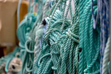 Green ropes coiled on harbor dock