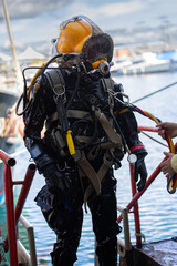 Commercial diver exiting water at harbor
