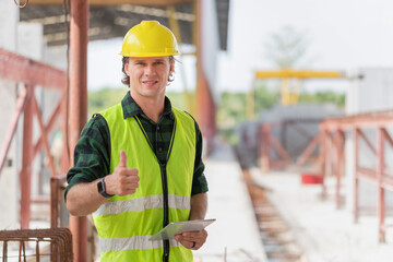 Happy engineer man with doing thumbs up gesture, Cheerful foreman worker with digital tablet on a...