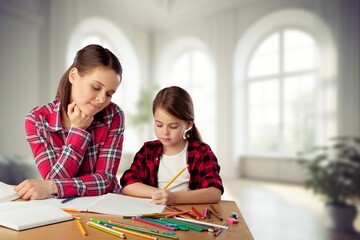 Cheerful and happy mom and daughter together at home