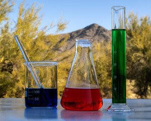 Chemicals glass containers outside in front of a mountain