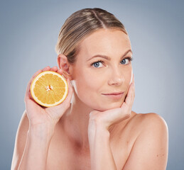 Portrait, orange and skin care with woman in studio for facial treatment, natural glow or wellness...