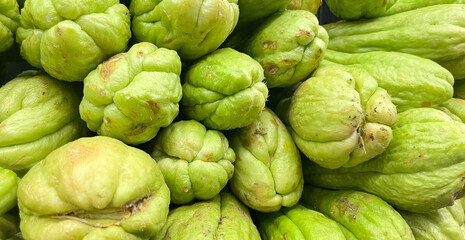 Freah chayote or Sechium edule on market for sale.Freah chayote background.Is a very useful vegetable.