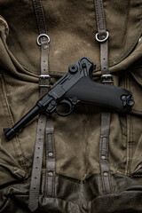 German vintage 9mm pistol from the Second World War. Background from an old canvas military...