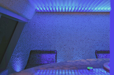 Finnish or dry sauna with oceanview or view of the sea inside male locker room of spa or wellness...